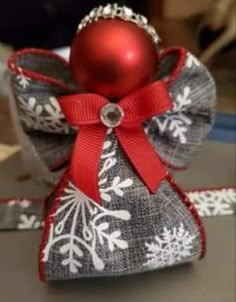 a red ornament sitting on top of a bag