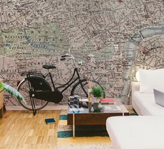 a living room with a couch, coffee table and wallpaper that has a bike on it