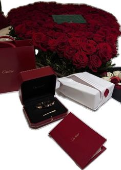 red roses in a box and two wedding rings