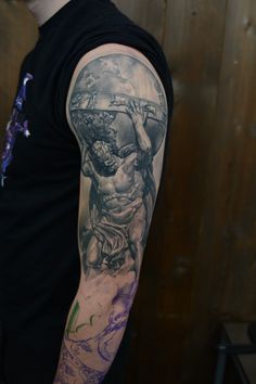 A tattoo of the greek titan god Atlas, holding the globe. Greek God Holding World Tattoo, Greek God Shoulder Tattoo, Man Holding World Tattoo, Atlas Shoulder Tattoo, World On Shoulders Tattoos, Atlas Holding The World Tattoo, Holding The World Tattoo, Atlas Tattoos, Snake Sleeve