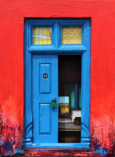 a red and blue building with an open door