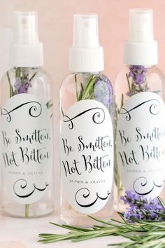 three bottles with lavender and rosemary in them