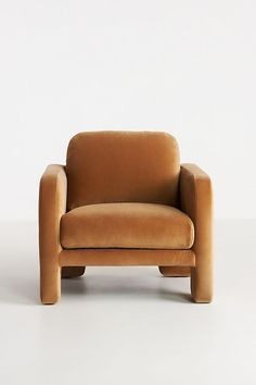 a brown chair sitting on top of a white floor