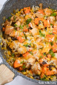 a skillet filled with chicken and vegetables