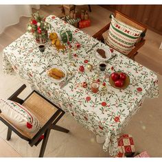 the table is set for christmas dinner with fruit, bread and other foods on it