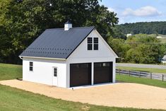 a two car garage in the middle of a field