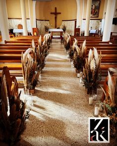 an empty church with rows of pews and flowers on the floor in front of them