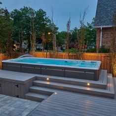 a hot tub sitting on top of a wooden deck