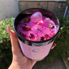 a person holding up a cup filled with liquid