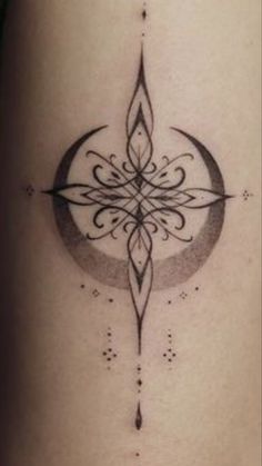 a black and white photo of a tattoo on the side of a woman's thigh