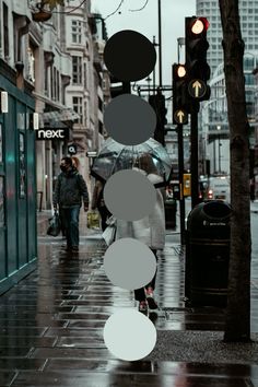 people walking down the street with umbrellas on a rainy day