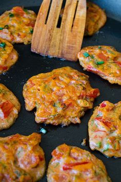 some food is cooking in a pan with a spatula