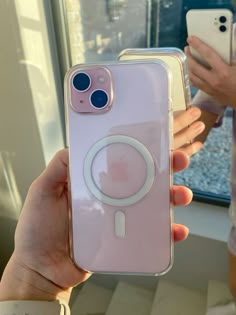 a person holding up an iphone case with a camera attached to the back of it