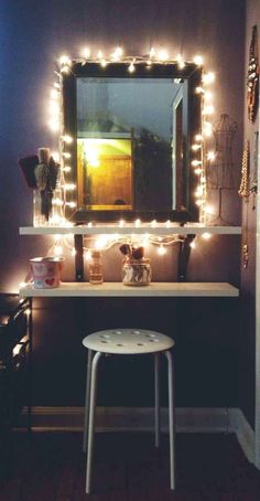 a vanity with some lights on it and a mirror