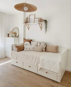 a bedroom with a bed, dressers and shelves on the wall next to it