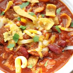 a white bowl filled with chili and cheese