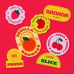 several stickers on a pink background with oranges, apples, and banana labels