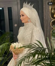 a woman in a white wedding gown and tiara