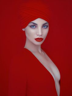 a mannequin wearing a red turban with blue eyes and lips, in front of a red background