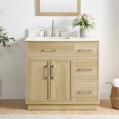 a bathroom vanity with two sinks and a large mirror above it, in front of a white brick wall