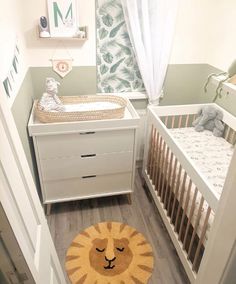 a baby's room with two cribs and a lion rug