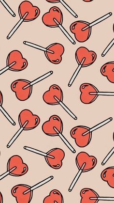 an image of heart shaped lollipops with sticks in them on a pink background