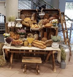 a table topped with lots of bread and pastries