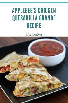 an appetizer's chicken quesadilla grandee recipe on a black plate with a bowl of salsa