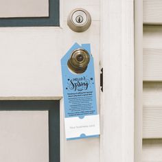 a door with a sign on it that says hello spring next to the door handle