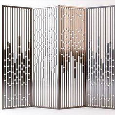 a room divider that is made out of metal bars and has an intricate design on it