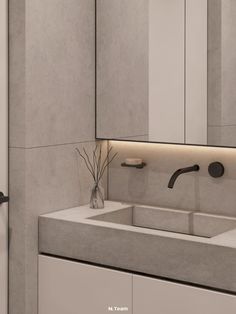 a bathroom with two sinks and a large mirror above the sink is lit by lights