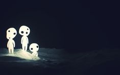 three little alien figures standing in the snow at night