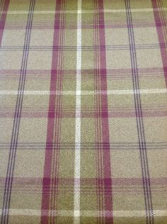 a plaid fabric with pink and white stripes on it's surface, as well as the