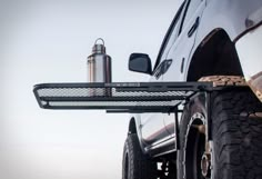 the front end of a truck with its lights on