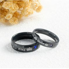 two black rings with the words king and queen engraved on them