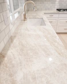 a kitchen counter top with a sink and faucet in the middle of it