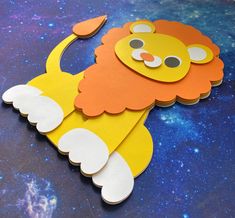 a paper cut out of a lion with space in the background