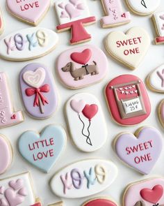 decorated cookies are arranged in the shape of hearts and other items for valentine's day