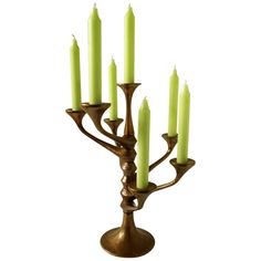 a brass candelabra with six lit candles in the shape of a tree