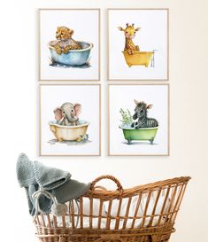 four pictures of animals are hanging on the wall next to a wicker basket with a stuffed animal in it