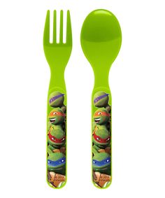 two green plastic forks and spoons with teenaged turtles on them, one is holding a fork