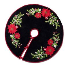 a black round rug with red poinsettis and green leaves on the center