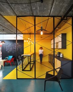 the interior of an office with yellow and black walls