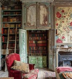 a living room filled with furniture and bookshelves covered in floral wall coverings