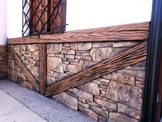 a stone wall with wooden slats on it