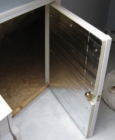 an open door is shown in the corner of a room with white walls and flooring