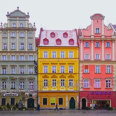 several colorful buildings line the street in front of each other