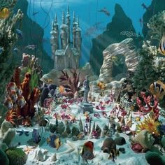 an underwater scene with many different types of fish and corals on the bottom right