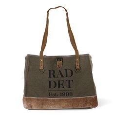 Introducing the RAD Canvas Bag – a versatile companion that seamlessly blends modern style with rustic charm. Featuring green canvas, brown leather handles, and natural brass hardware, this bag exudes a timeless yet contemporary appeal. The sturdy bottom, made of neutral hair-on-hide, adds durability and an earthy texture. With a spacious interior and outer pockets for convenience, the RAD Canvas Bag is the perfect fusion of modern functionality and rustic allure. Brown Canvas Weekender Bag With Top Carry Handle, Modern Brown Canvas Bag For Errands, Brown Canvas Bag With Leather Trim For Errands, Brown Coated Canvas Bags With Brass Hardware, Brown Coated Canvas Bag With Brass Hardware, Khaki Canvas Tote Bag With Leather Handles, Brown Coated Canvas Shoulder Bag With Brass Hardware, Khaki Canvas Satchel With Double Handle, Green Bags With Leather Trim For Shopping