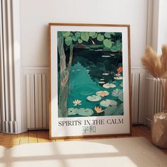 there is a framed poster on the wall next to a vase with water lilies